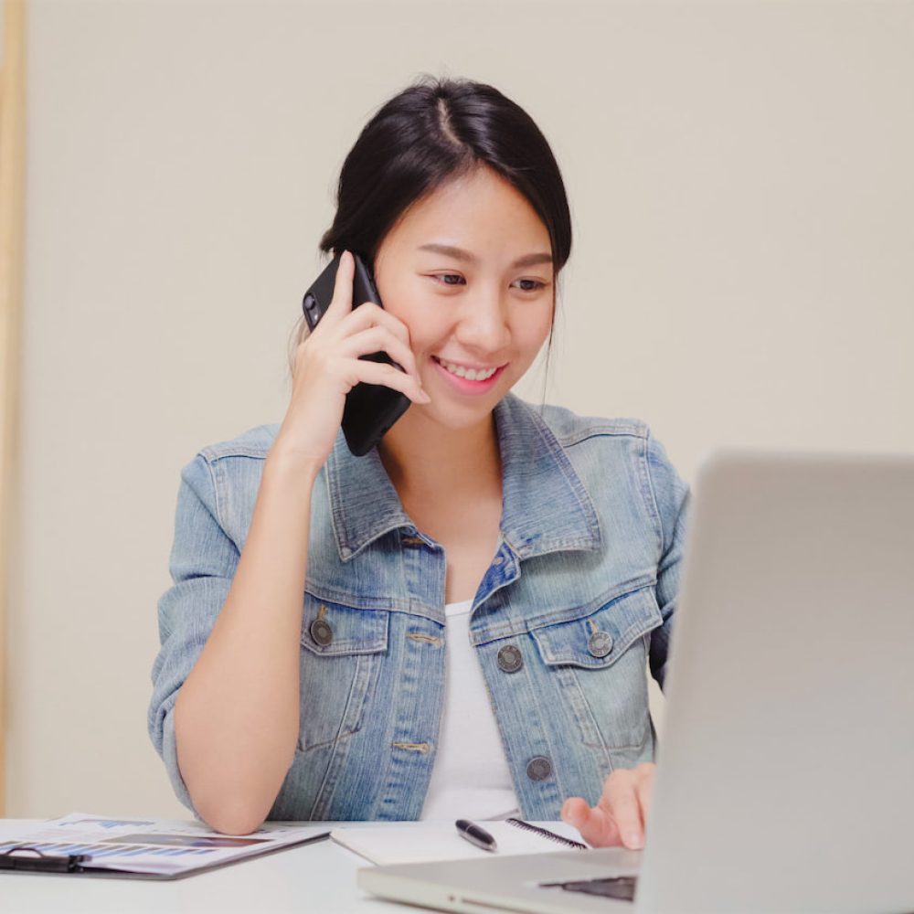 beautiful-smart-business-asian-woman-smart-casual-wear-working-laptop-talking-phone-while-sitting-table-creative-office X1500 beautiful-smart-business-asian-woman-smart-casual-wear-working-laptop-talking-phone-while-sitting-table-creative-office X1500